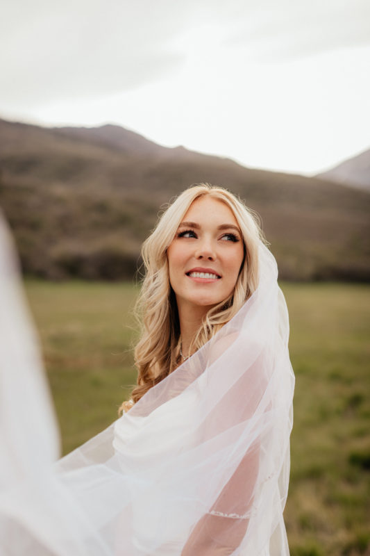 Hailey's story has a happy ending: an image of Hailey, in her bridal gown on her wedding day, standing on a green field with mountains behind her, smiling and looking off into the distance over her shoulder